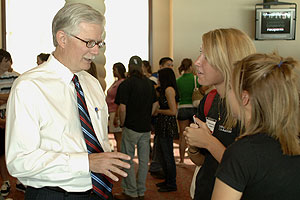President Jon Whitmore talks to scholarship recipients. Each recipient also received a laptop computer equipped with programs the students will use in their academic major.